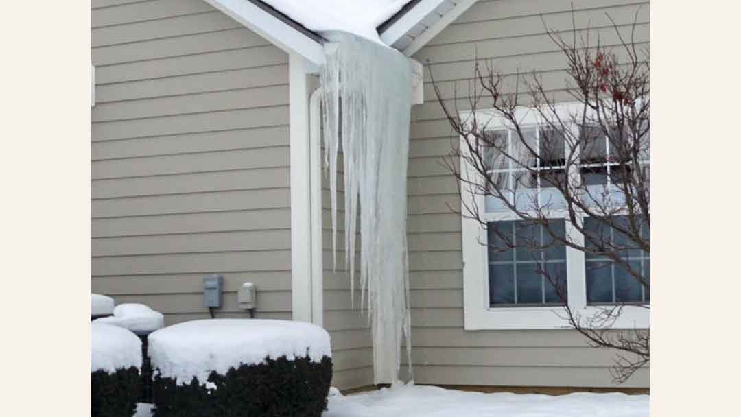 house with long icicles hanging from gutter